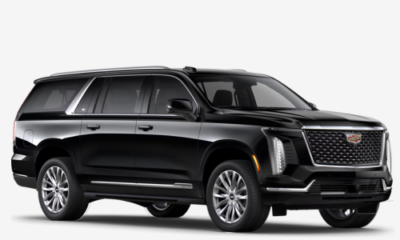 A black Cadillac SUV with a luxurious exterior, showcasing a prominent grille and alloy wheels.